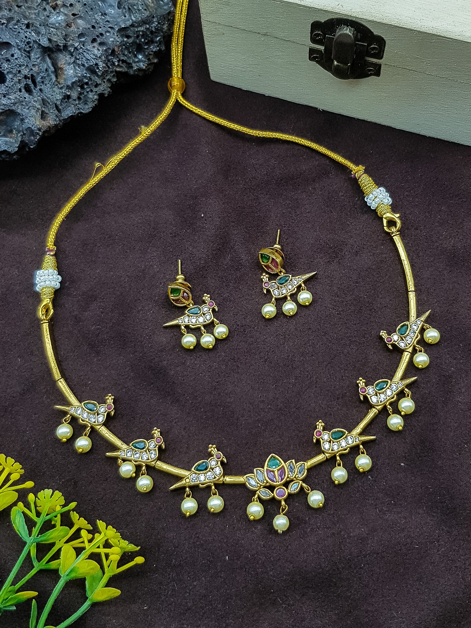 Pipe necklace with peacock motif