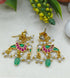 Jadau earrings with gold, green, and pink colors on a light background with leaves and flowers.